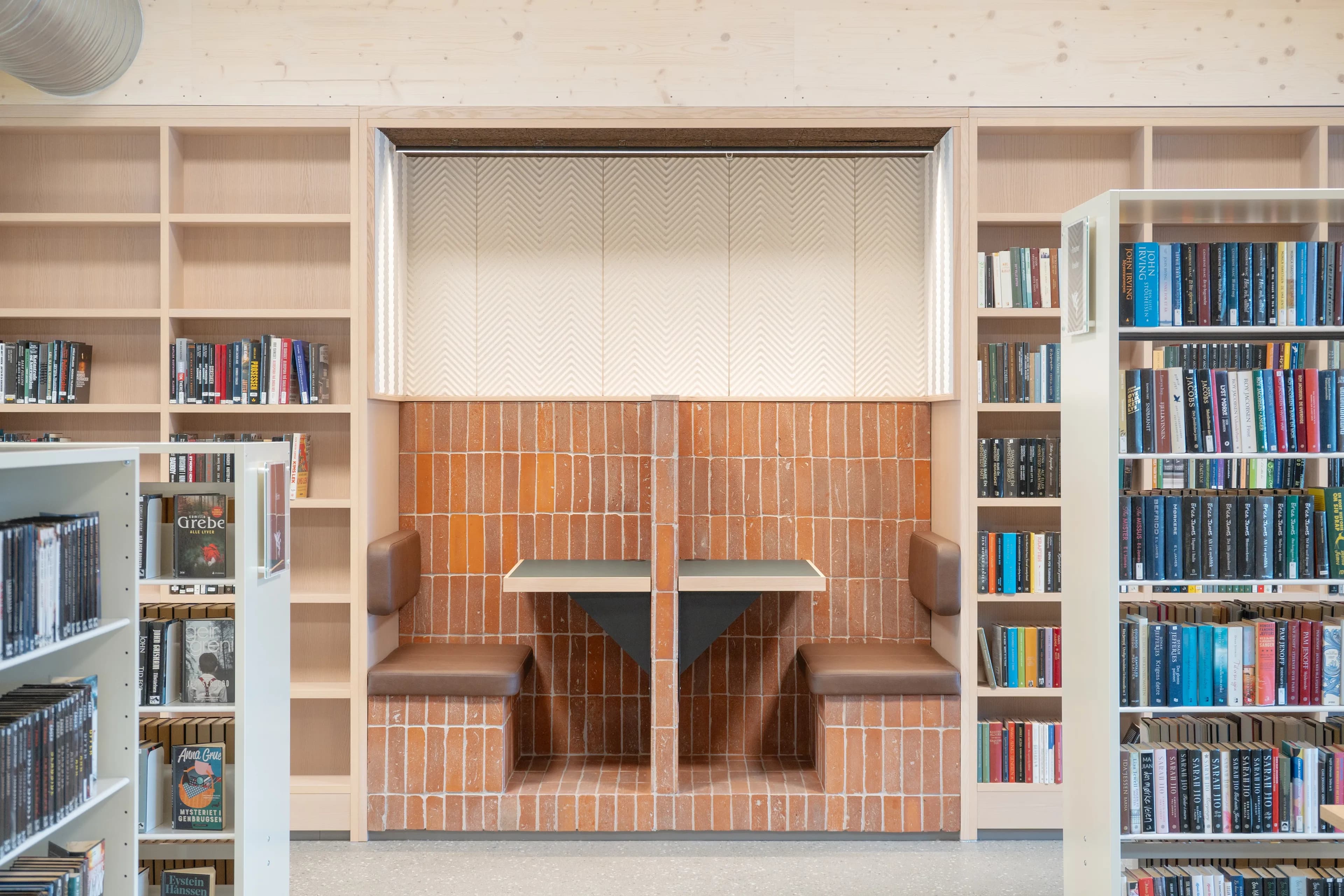 A custom-built brick seating nook at Sarpsborg Library.